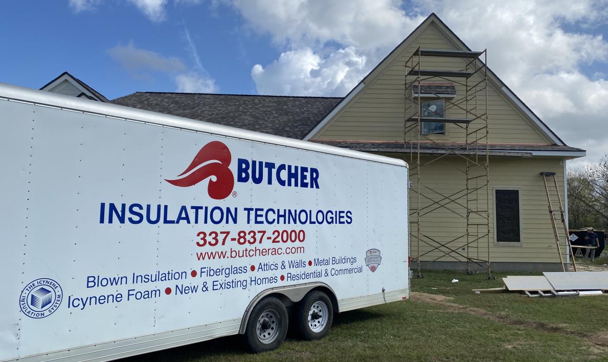 Image of Butcher Insulation’s company trailer in front of a job site
