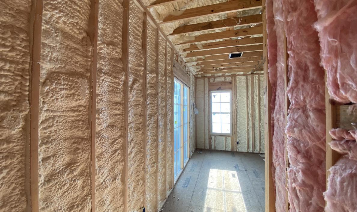 Image of a building with interior wall spray foam insulation and fiberglass insulation