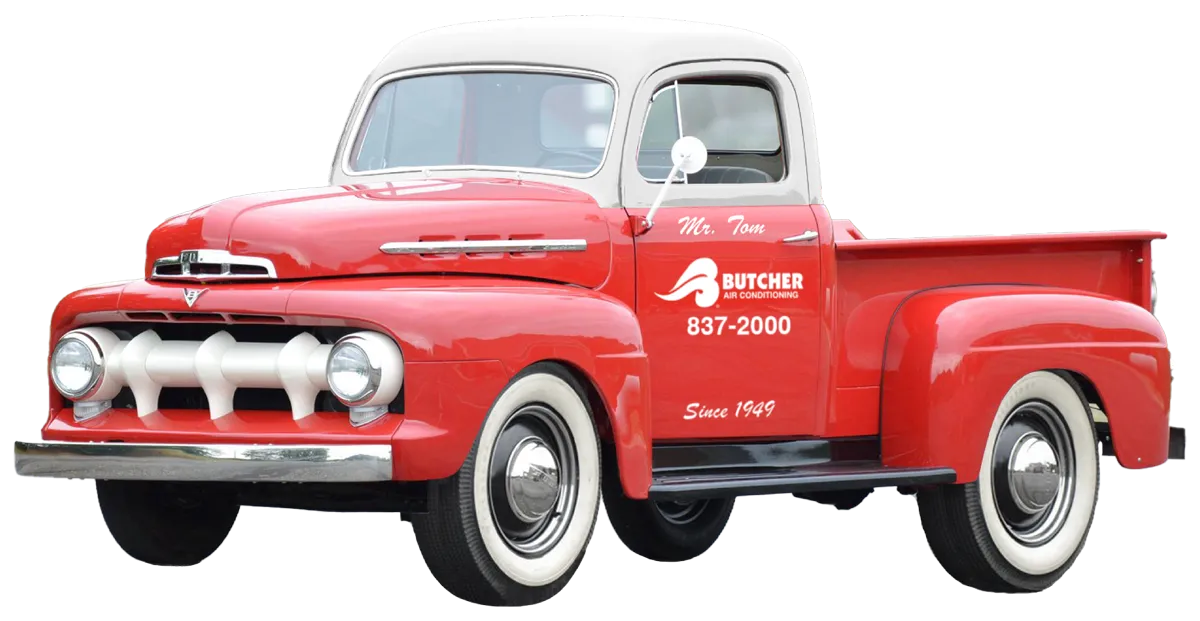 Red 1950s vintage pickup truck with Butcher Air Conditioning logo, white roof and whitewall tires
